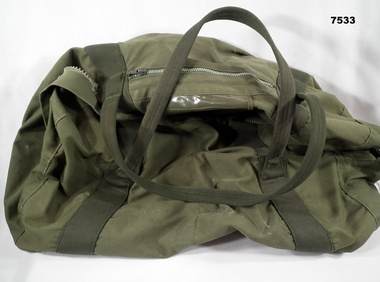 Green Army issue kit bag for carrying personal effects.