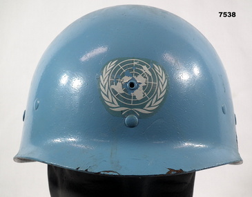 Blue painted helmet with United Nations markings.
