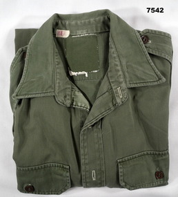 Jungle green coloured long sleeved cotton Army issue shirt.