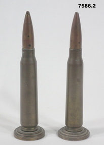 Two mounted 50 cal bullet casings.