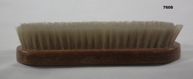 Army issue clothes brush with wooden handle.