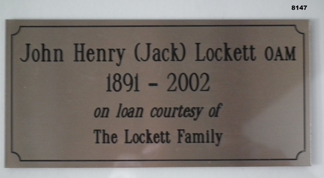 Plaque on the water colour painting re jack Lockett.