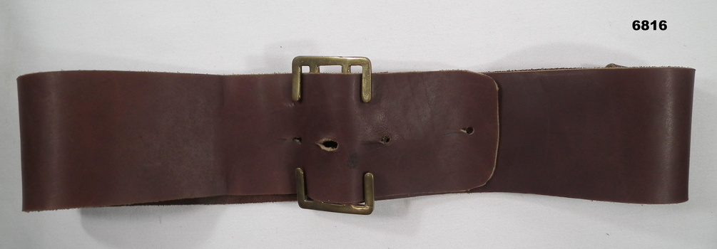 Broad brown leather uniform belt.