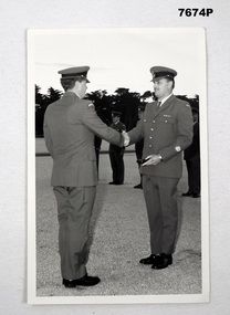 Photo of Peter Stocklahsa in uniform receiving presentation box.