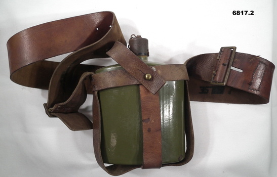 Enamel water bottle with leather carrier.