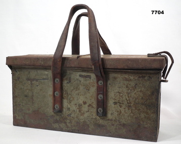 Metal box with hinged lid and leather handles.