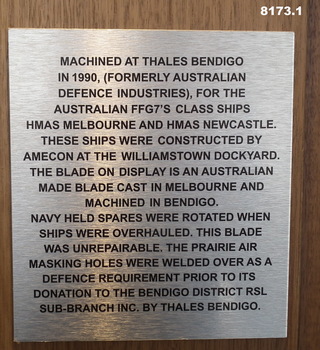 Plaque re a propellor blade of a Navy ship.