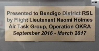 Plaque on frame relating to Operation Okra.