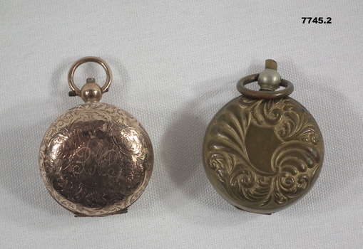 1. Rose Gold coloured hinged sovereign case with engraved name. 2. Brass coloured hinged sovereign case.