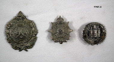 Three silver coloured metal cap badges from British Regiments.
