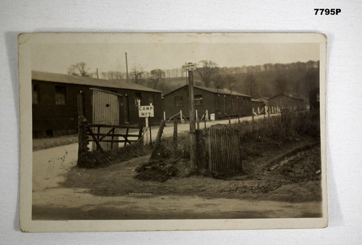 Black and white photograph of a series of buildings fronting a road.