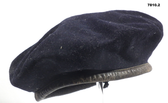 Army great coat and beret.