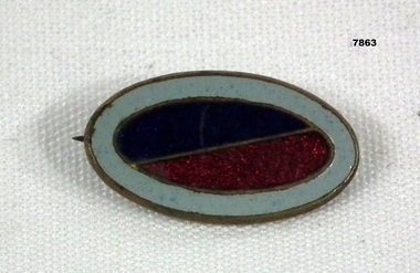 Enamel and metal association badge featuring red over blue.