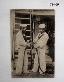 Black and White postcard depicting two sailors in uniform handling rope.