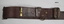 Brown leather belt with brass buckle.