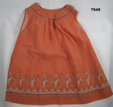 Orange girls top with embroidery.