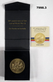 Gold coloured medallion in box to commemorate the 60th Anniversary of the end of WW2.