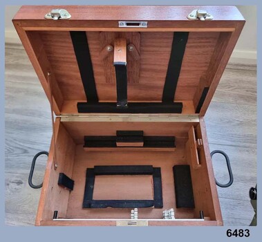 Wooden Oak Box that holds a green stereoscope with accessories