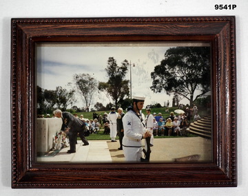 Framed photo of a wreath laying ceremony.