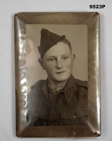 Framed sepia colour portrait photograph.