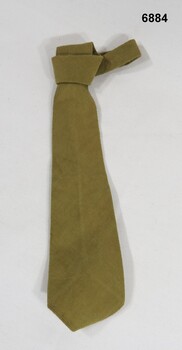 Khaki cotton tie worn with uniform.
