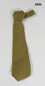 Khaki cotton tie worn with uniform.