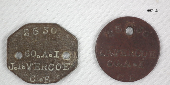 Two WW1 identity discs, one circular, one octagonal.