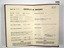 Open Certificate of Discharge in brown buckram folder.
