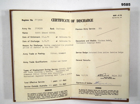 Open Certificate of Discharge in brown buckram folder.