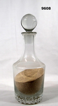 Glass carafe of sand from Tobruk.