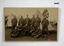 Postcard photo of a group of soldiers in camp.