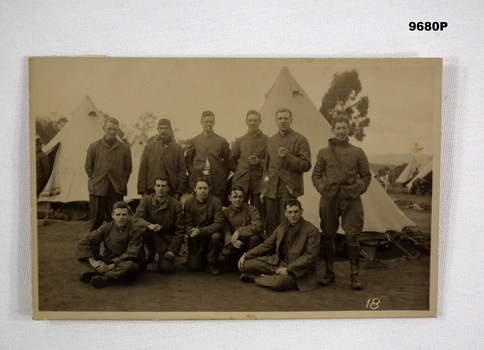 Postcard photo of a group of soldiers in camp.