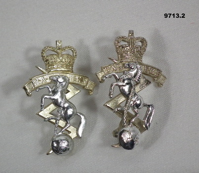 Pair of RAEME hat badges.