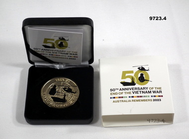 Circular gold coloured Vietnam War Commemorative medallion.