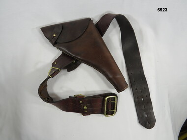 Leather Sam Browne belt with pistol holster.