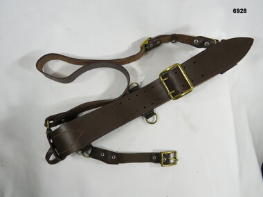 Leather Sam Browne belt with shoulder strap.