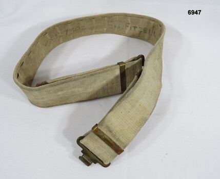 Belt webbing khaki with brass buckle.