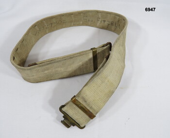 Belt webbing khaki with brass buckle.