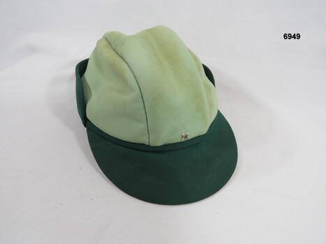 Women's dress hat with small peak at front.