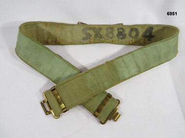 Khaki webbing belt with brass fittings.