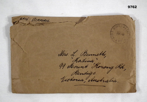 Brown paper envelope with handwritten address in black ink.