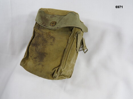 Khaki ammunition pouch with additional side pockets.