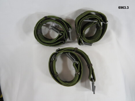 Three nylon, adjustable belt webbing with plastic buckles.