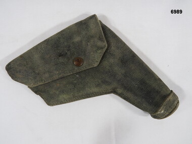 Worn, blackened over khaki pistol holster.