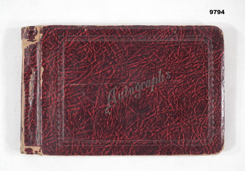 Hard cover autograph book with handwritten messages on coloured paper pages.
