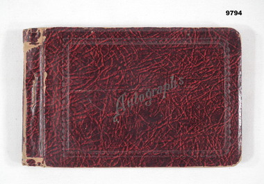 Hard cover autograph book with handwritten messages on coloured paper pages.