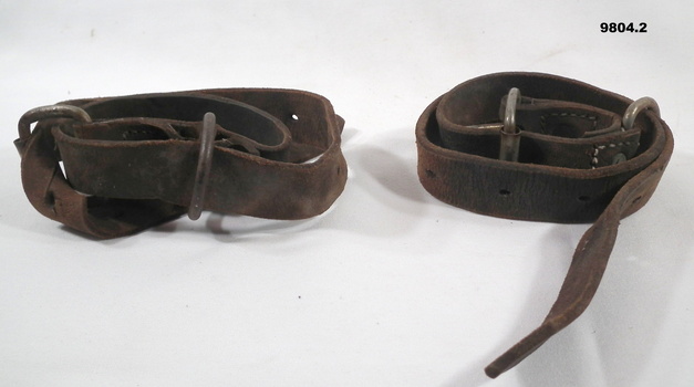 Two brown leather belt straps.