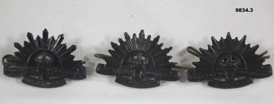 Set of three Rising Sun collar badges.