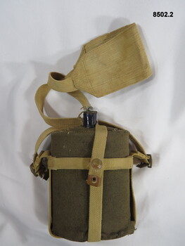 Woollen covered water bottle and shoulder harness.