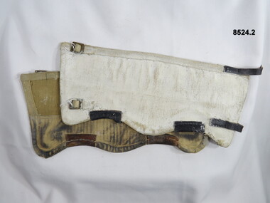 Pair gaiters, white on outside with brass buckles and leather straps.